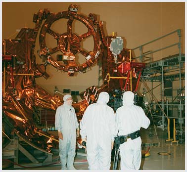 Three suited workers with a payload rig.